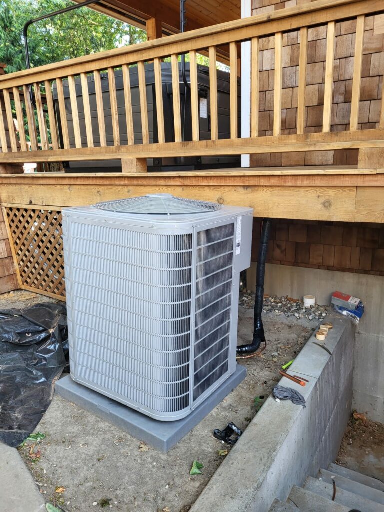 Home Air Conditioning Unit Installation Beside Wooden Deck